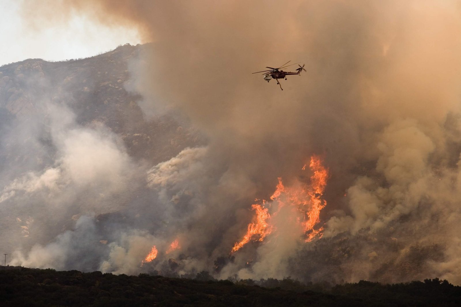 Helicopter water drop on wildfire